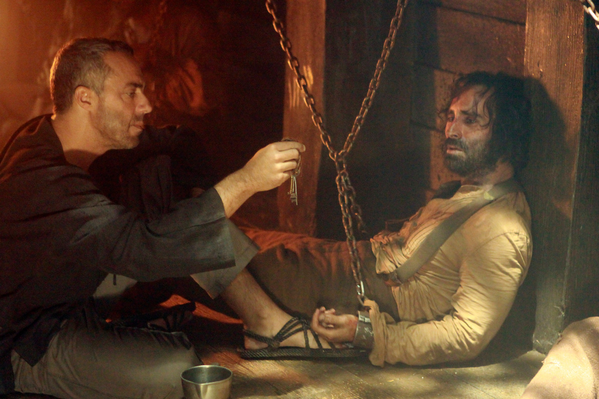 Titus Welliver dangles keys in front of a chained Nestor Carbonell.