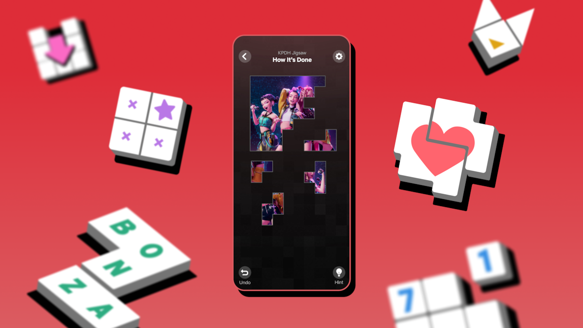 A smartphone displays a puzzle game with a music group image, surrounded by floating game tiles with symbols and letters on a vibrant red background, creating a playful and lively atmosphere.