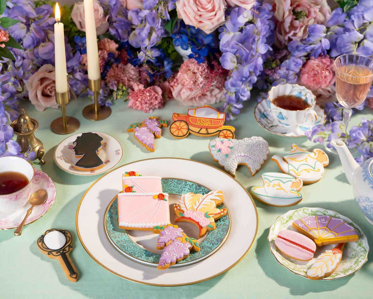 A table decorated with flowers showcases biscuits from the ‘Bridgerton’ collaboration with Biscuiteers