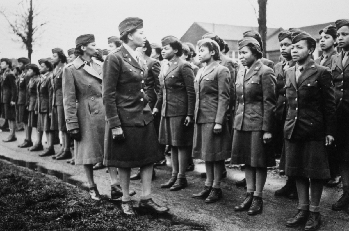 Captain Mary Kearney and American WAC Commanding Officer Major Charity Adams (1918-2002) inspect the first arrivals to the 6888th Central Postal Directory Battalion at a temporary post in Birmingham, West Midlands, England, 15th February 1945. The 6888th (known as the 'Six Triple Eight') was the only all-African-American WAC unit sent to Europe during World War II, with responsibility for clearing backlogged mail in England and France.