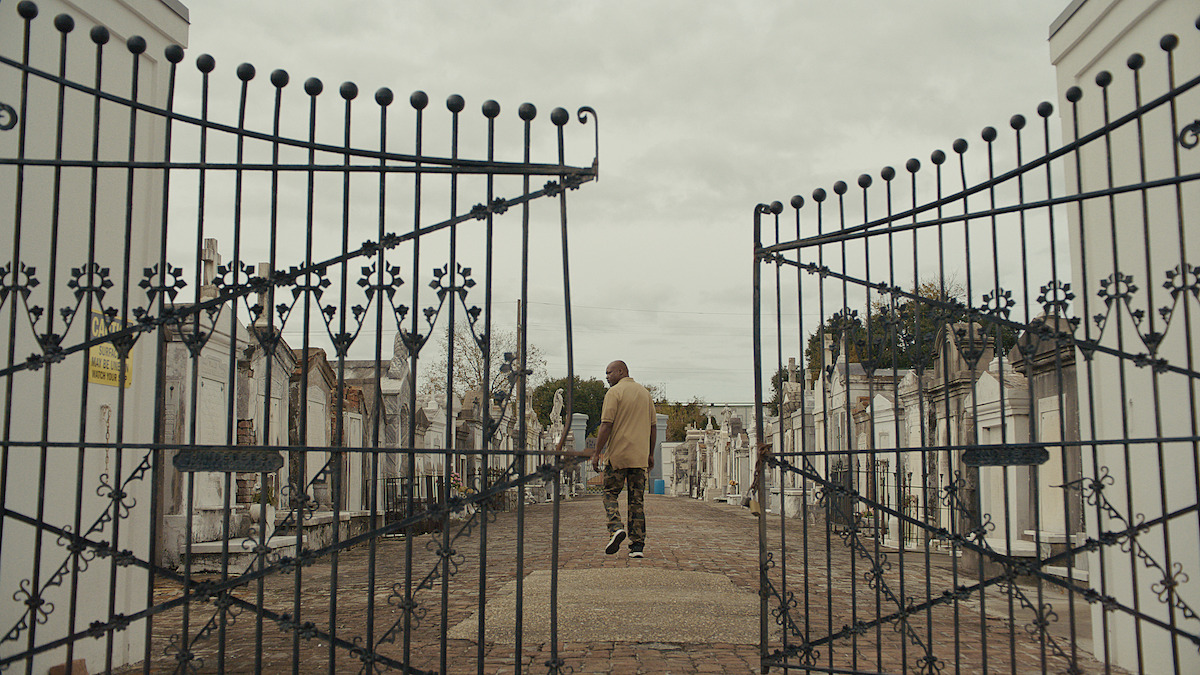 A man stands in a cemetery.