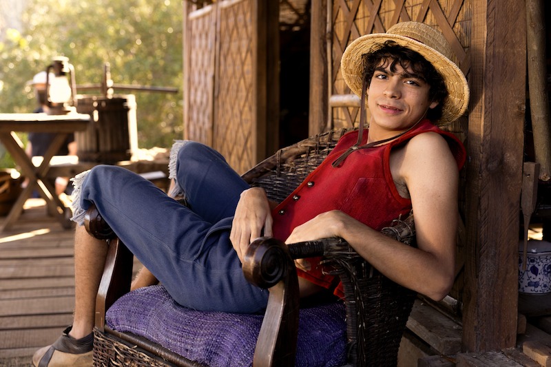 Iñaki Godoy as Monkey D. Luffy sits in a chair on the set of Season 1 of 'One Piece.'