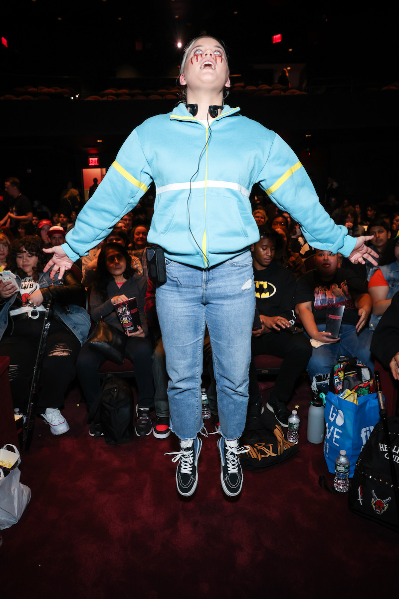 Max levitates at the Stranger Things Day screening in New York City, cassette player on hand.