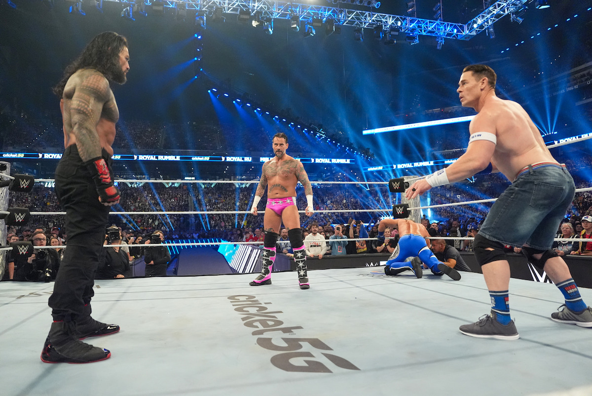 Roman Reigns, CM Punk, and John Cena in the ring during Royal Rumble