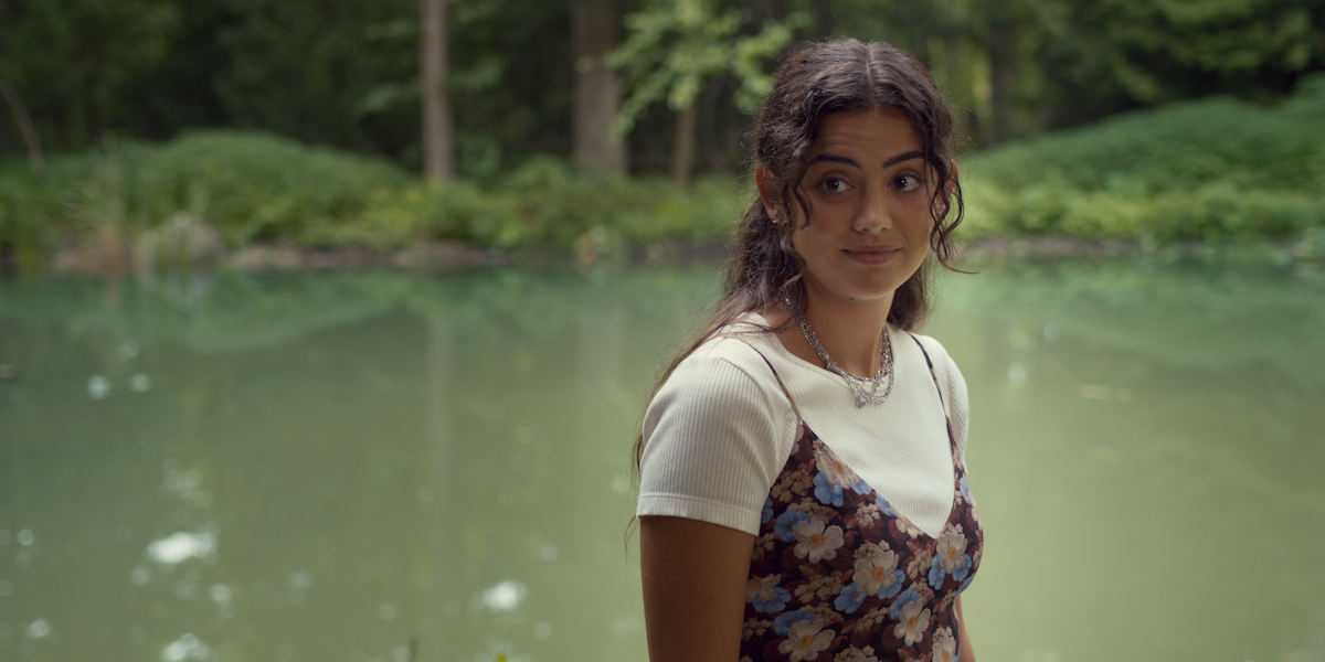 Sadie Laflamme-Snow as Alice stands in front of a pond in a production still from ‘The Way Home.’