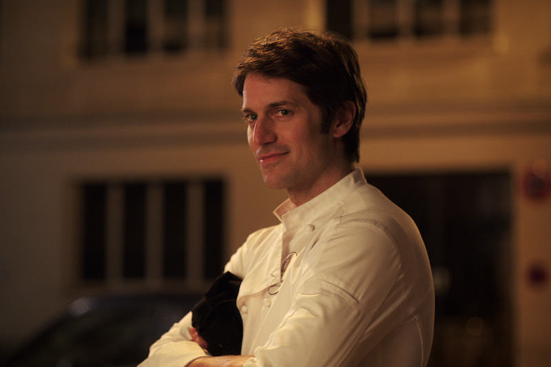 Lucas Bravo as Gabriel wears a chef coat in Season 4 of 'Emily in Paris'