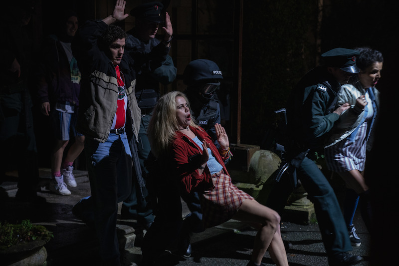 James (Llewellyn), Erin (Jackson) and Michelle (O’Donnell) get escorted by the police.  - ‘Derry Girls’ Season 3 Photos