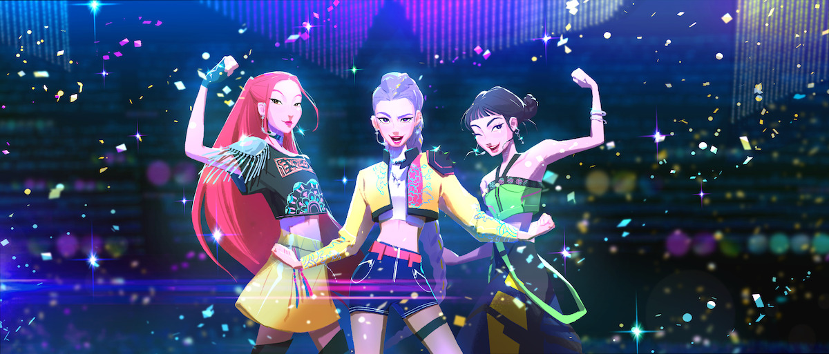 Mira, Rumi, and Zoey from 'KPop Demon Hunters' in stylish, futuristic outfits pose confidently on a vibrant, colorful stage with confetti and sparkles, suggesting a lively concert or dance performance in a digital environment.