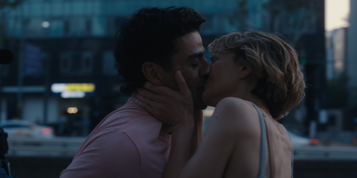 A man and woman kiss in the streets of Seoul, Korea.