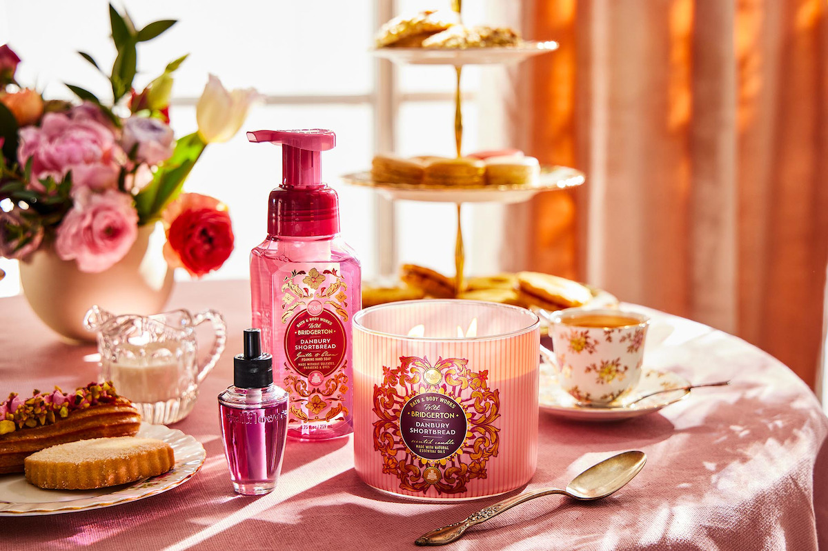 A round table adored with pink perfume, candles, teacups and spoons for the ‘Bridgerton’ collaboration with Bath & Body Works
