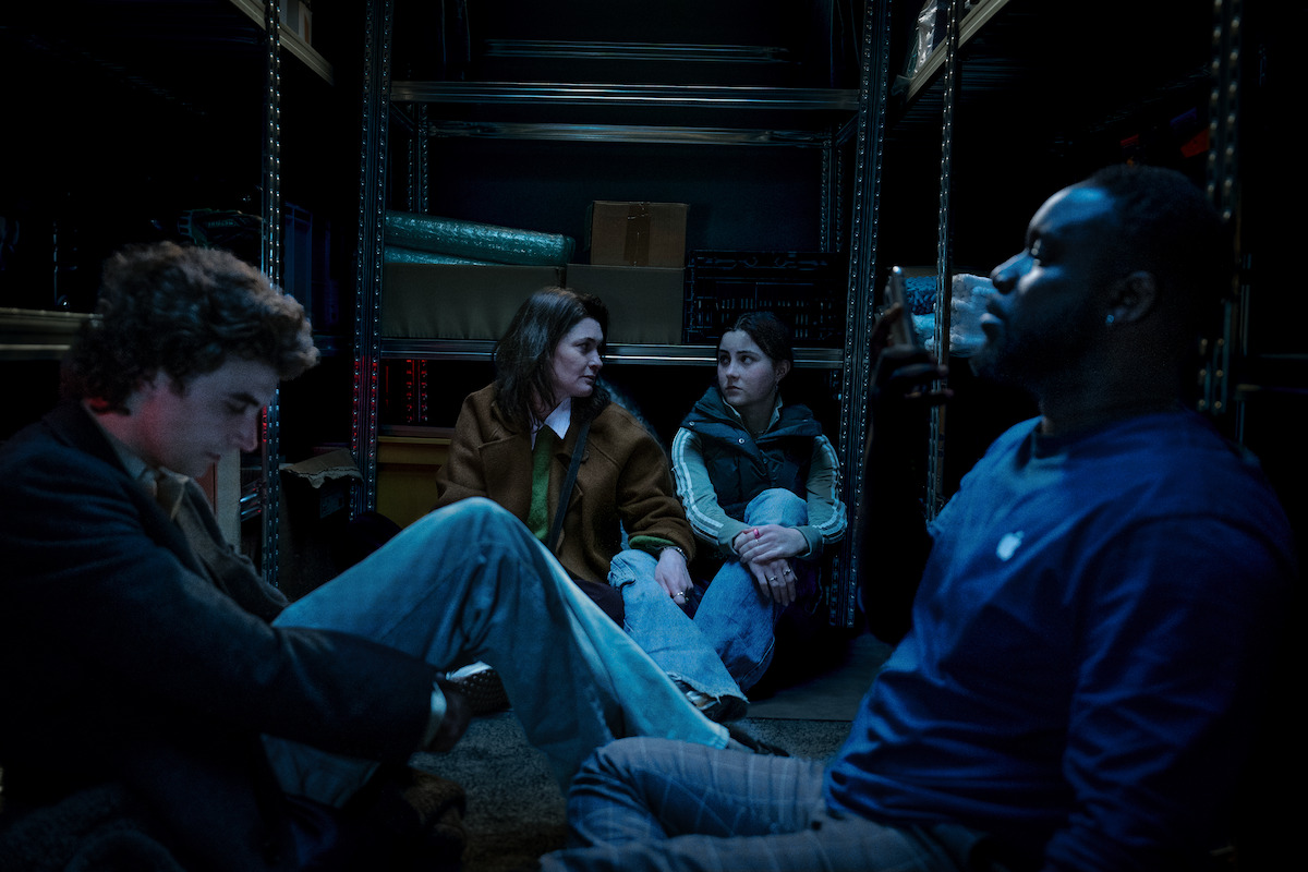 Hostages hide in a supply closet in an image from the film ‘iHostage.’