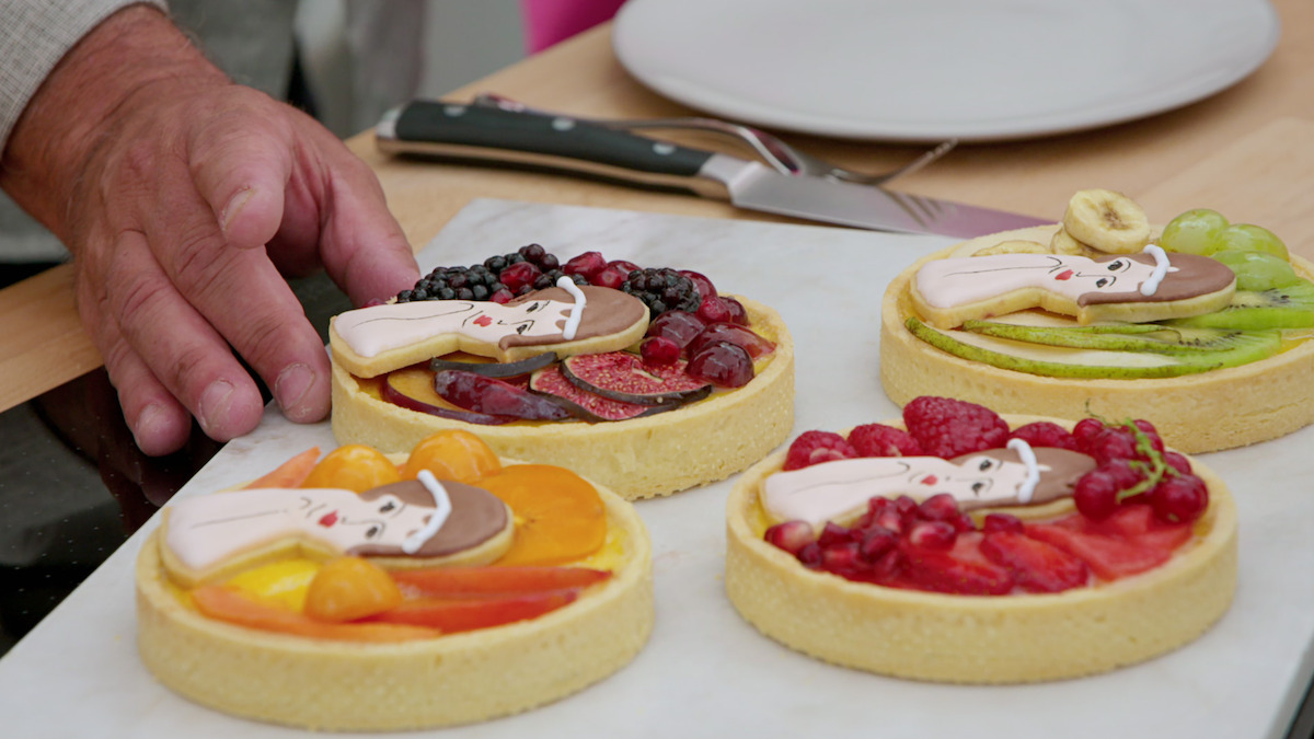 Various vanilla fruit glazed pies are topped with flappers to celebrate 1920s week on The Great British Baking Show