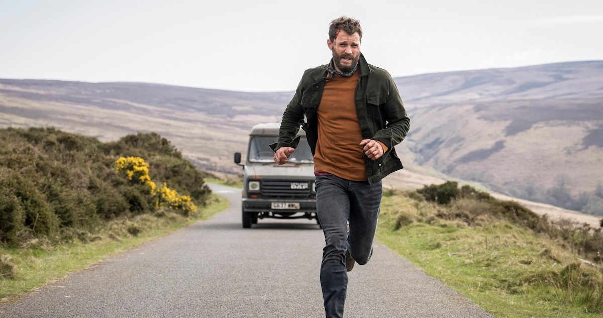 Jamie Dornan runs from a car in the wilderness in season 2 of 'The Tourist'