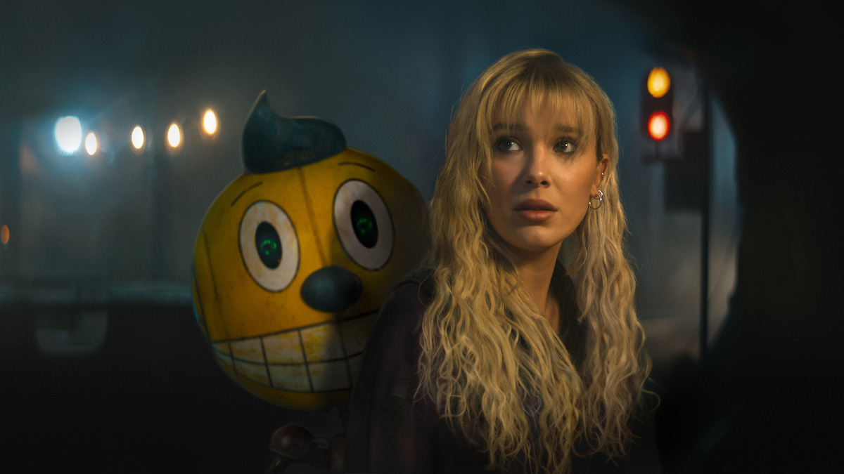 Cosmo, voiced by Alan Tudyk, and Millie Bobby Brown as Michelle in ‘The Electric State’