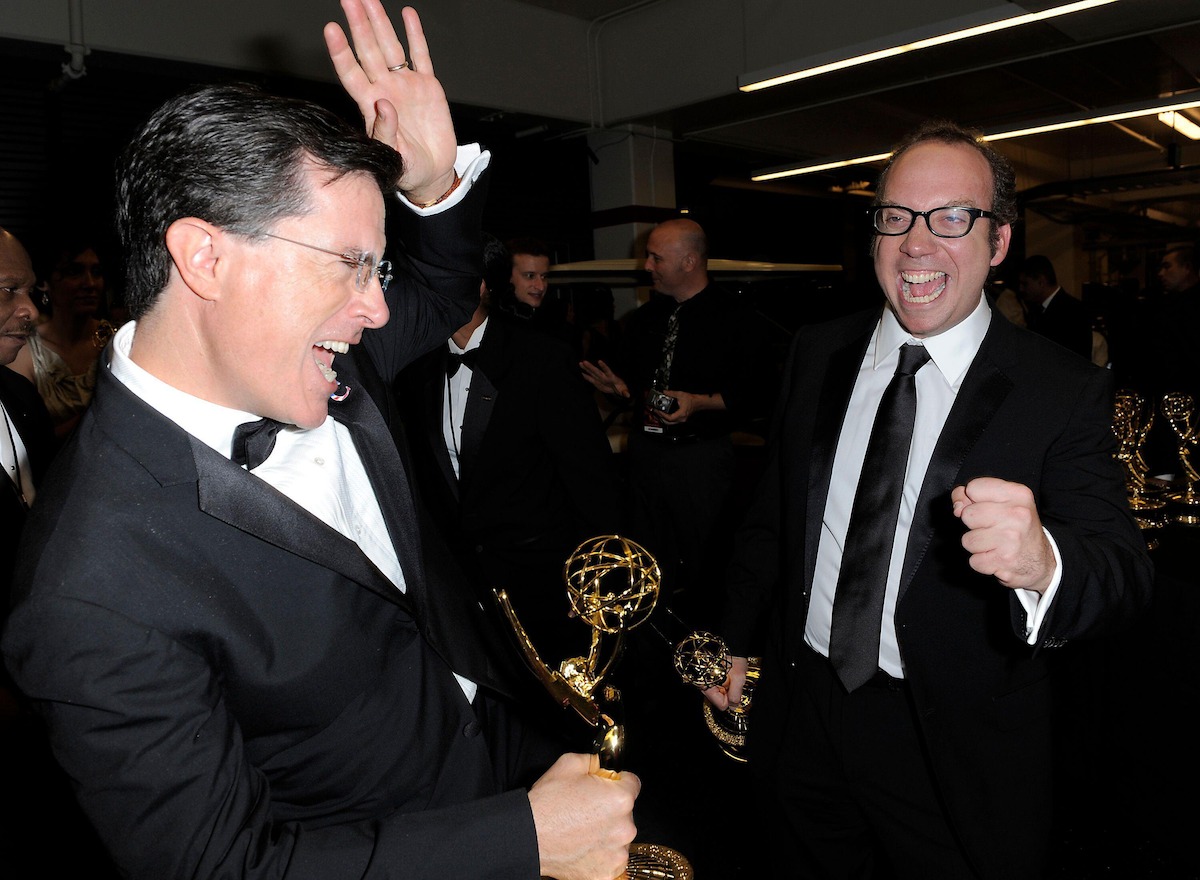 Giamatti celebrates his John Adams Emmy win backstage with another winner of the evening, Stephen Colbert.