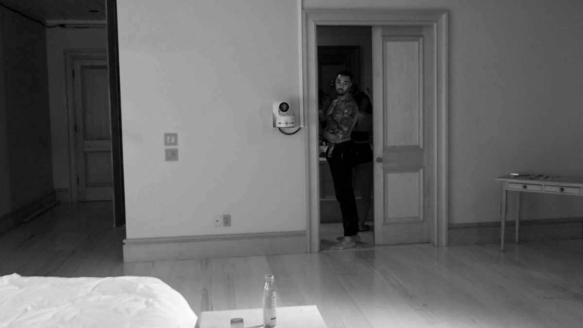 A night-vision shot of Brion looking out from the bathroom.