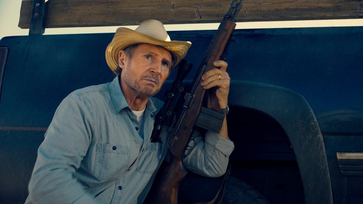 Liam Neeson as Jim Hanson readies his gun in ‘The Marksman.’
