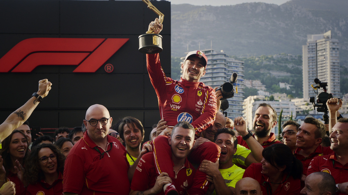 Charles Leclerc lifted up by his team as he holds the Monaco Grand Prix tophy.