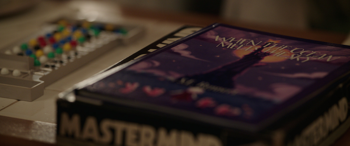 A picture of a book called When the Ocean Meets the Sky by S.E. Rennert on a table.