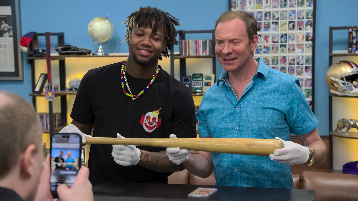 Ronald Acuña Jr. and Ken Goldin holding up a baseball bat
