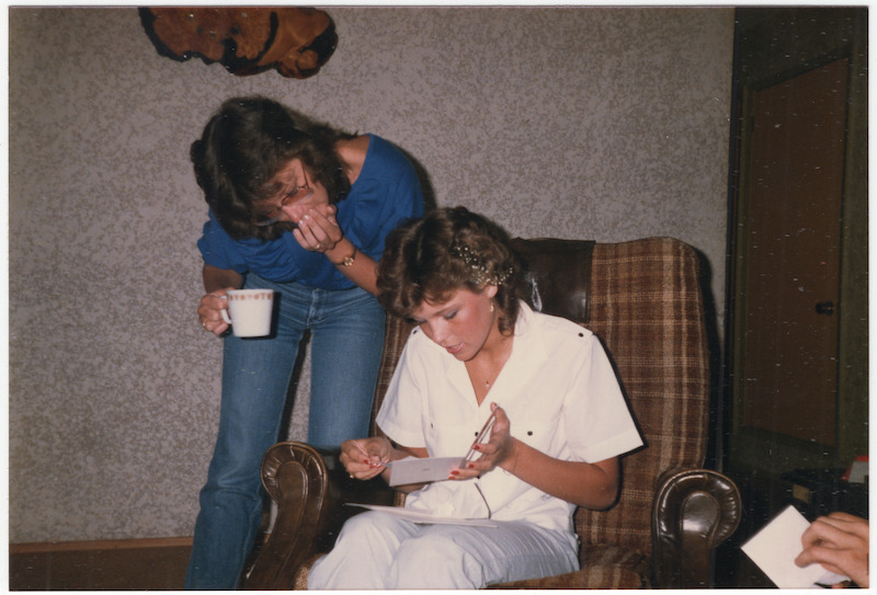 Pamela opening a card at home.