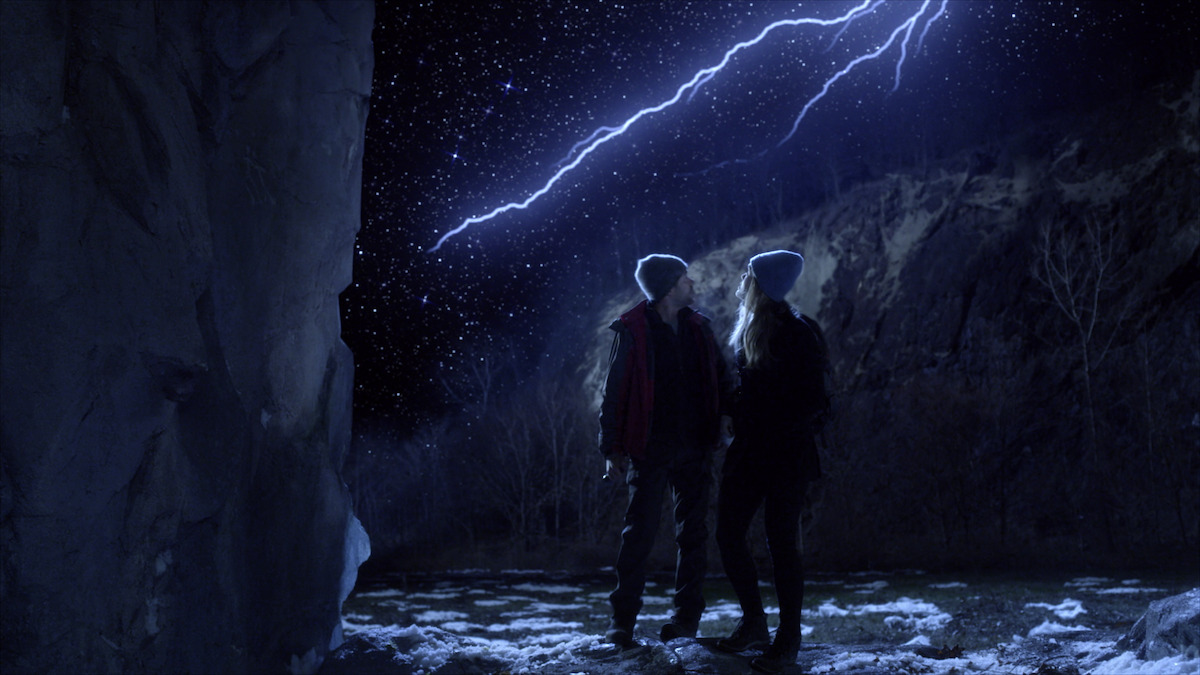 A couple looks at lightning. 