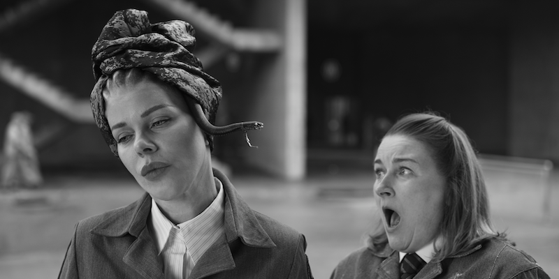 Black and white image of Debi Mazar as Medusa 
with a snake popping out of her headscarf in Season 1 of ‘Kaos’