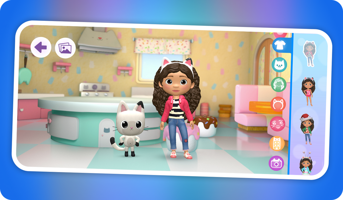 Animated girl with cat ears and a cat companion stand in a colorful, cartoon kitchen. Interface options for customization are shown on the side, suggesting an interactive dress-up game on a mobile device.