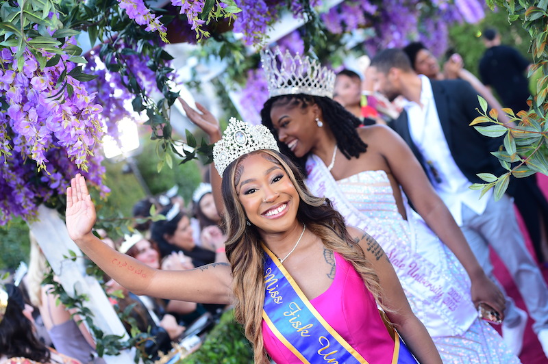Miss Fisk University smiles and waves on the Queen Charlotte red carpet