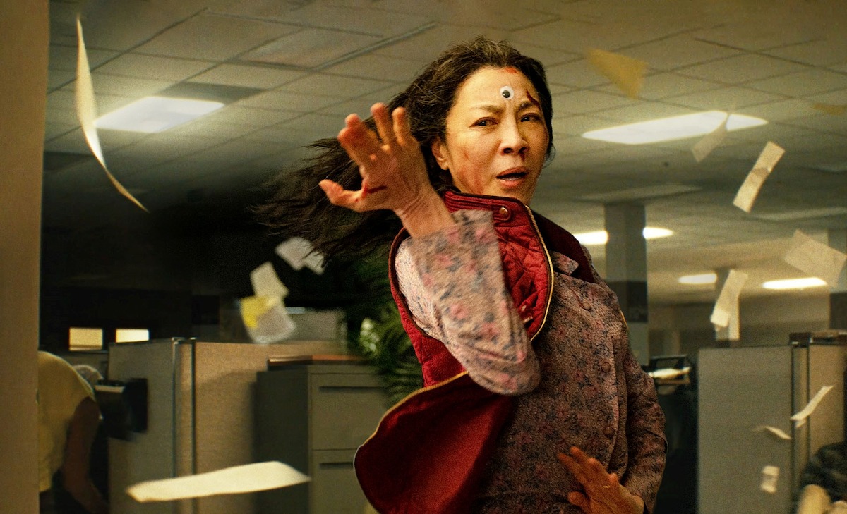 Michelle Yeoh strikes an action pose with a googly eye on her forehead in ‘Everything Everywhere All at Once’