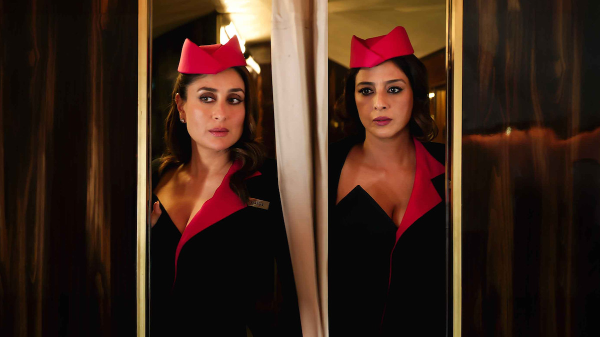 Kareena Kapoor as Jasmine Kohli and Tabu as Geeta Sethi wear flight attendant uniforms and stand in an airplane aisle in an image from the film ‘Crew.’