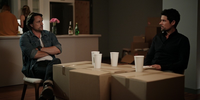L to R) Martin Henderson as Jack Sheridan, Benjamin Hollingsworth as Brady using cardboard boxes as a table. 