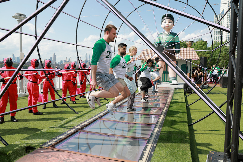 Fans compete during a 'Squid Game' Season 3 event at Domino Park in Brooklyn, New York.