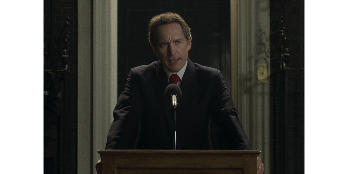 Tony Blair standing behind a podium