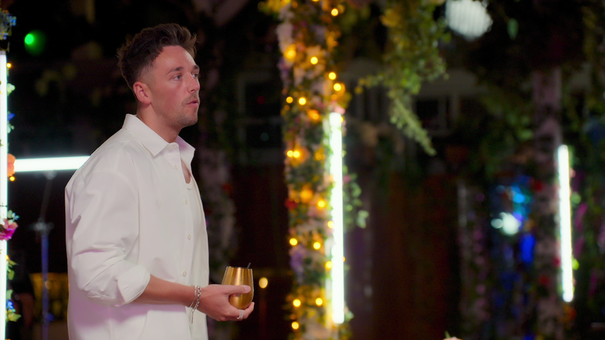 Sam holding a drink.