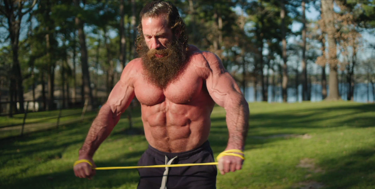 Brian Johnson aka the Liver King working out outside.