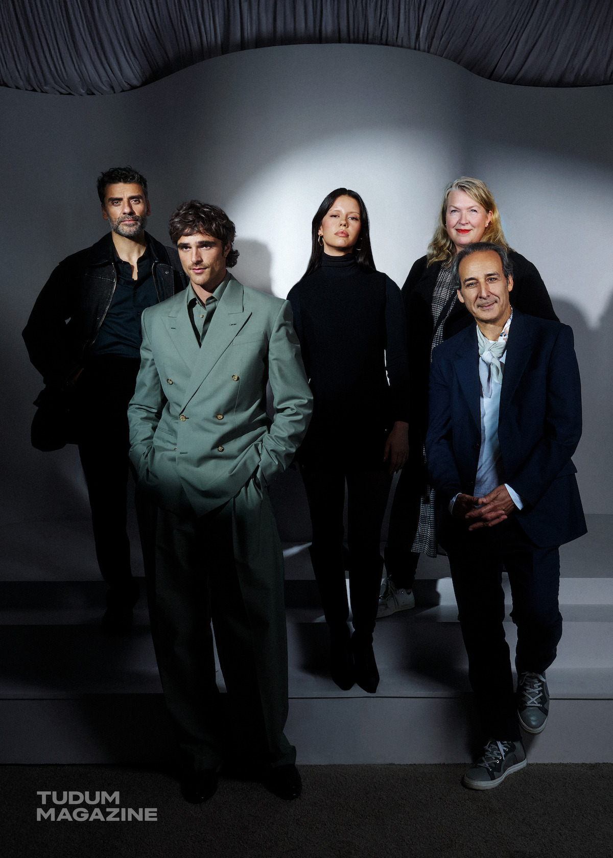 Oscar Isaac, Jacob Elordi, Mia Goth, Kate Hawley, and Alexandre Desplat stand against a white backdrop.