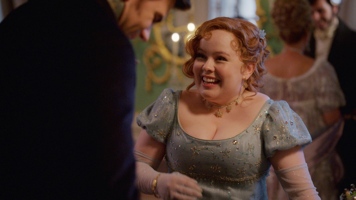 Nicola Coughlan as Penelope Featherington smiles at a ball in 'Bridgerton' Season 3 
