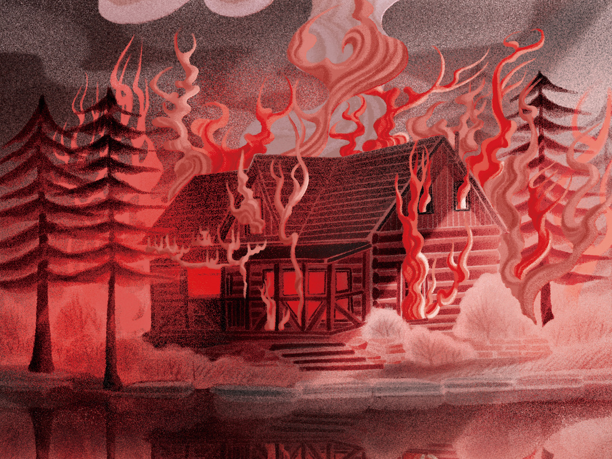 A cabin is engulfed by red flames by a lake.