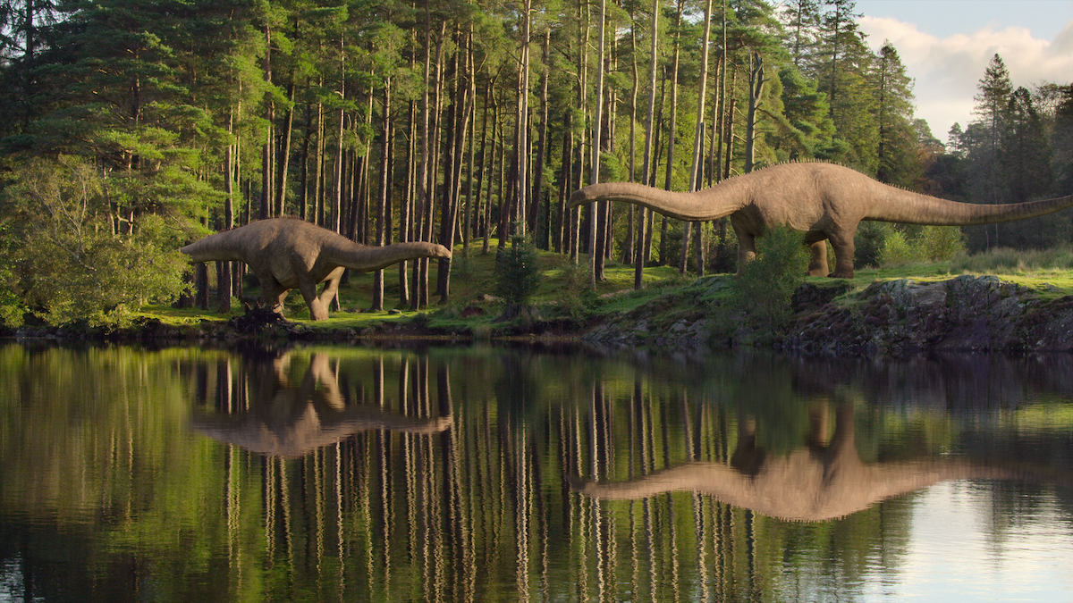 Two dinosaurs gather near a body of water in ‘Life on Our Planet.’