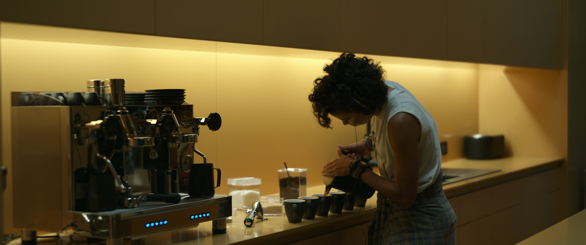 Lizzy makes coffee for fellow inmates - The Beauty of Brutalism: the Design References in ‘Spiderhead’ Revealed