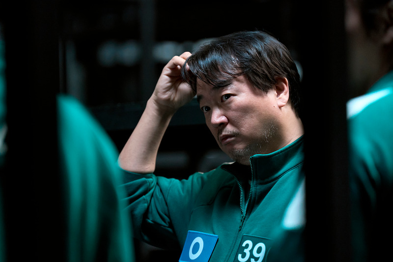 A man scratches his head in Season 2 of 'Squid Game'