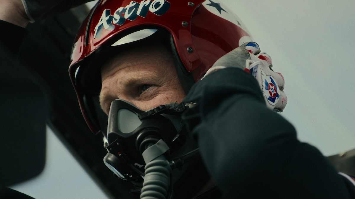 Pilot in a cockpit as other fighter jets fly by