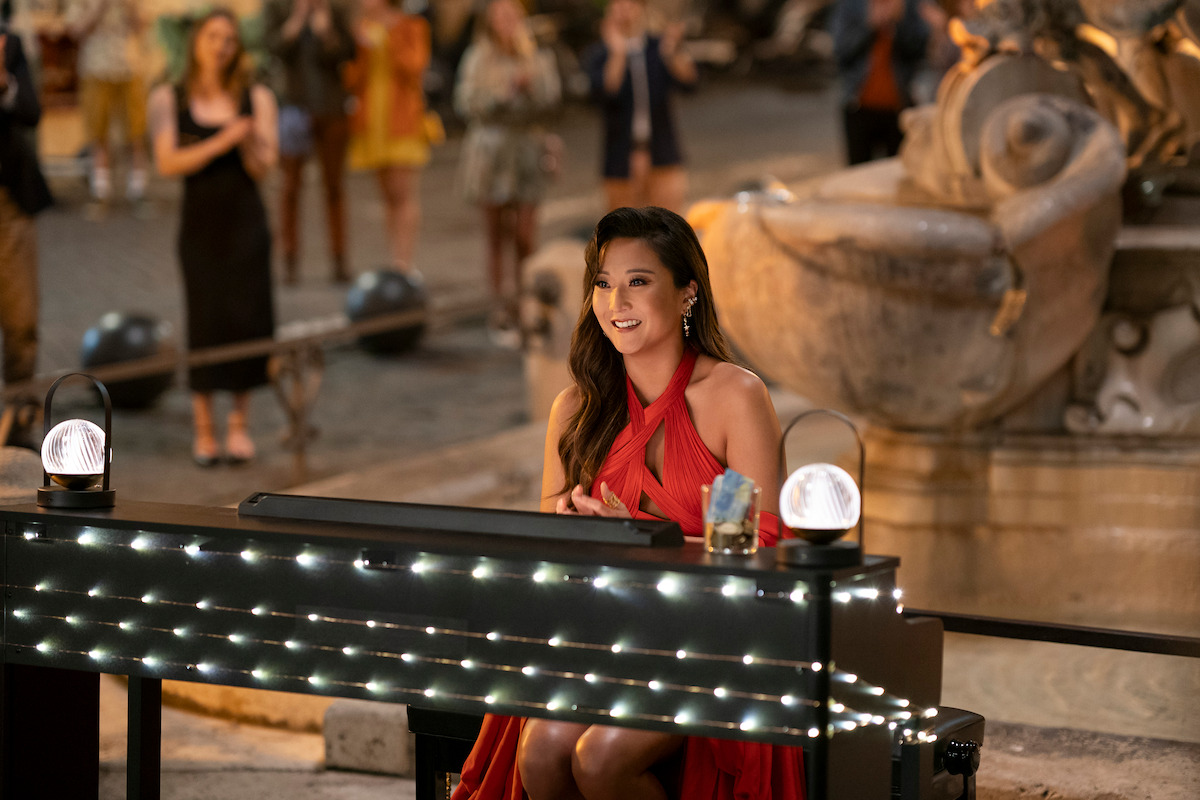 Ashley Park as Mindy performs at the Piazza Mattei in Season 4 of ‘Emily in Paris’