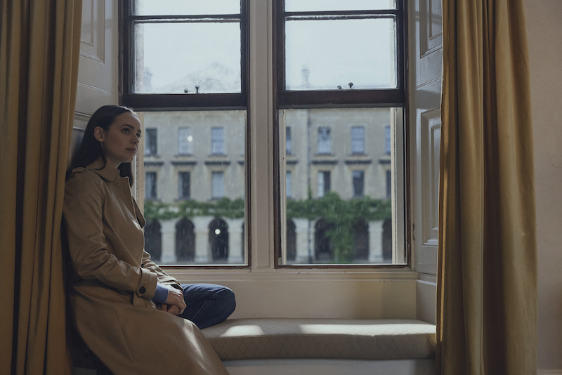 Sofia Carson as Anna sitting in front of a window in 'My Oxford Year'.