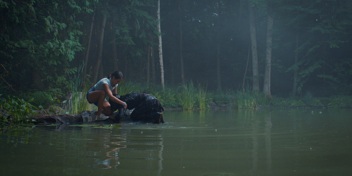 Alex Hook as teenage Kat saves Sadie Laflamme-Snow as Alice from drowning in the pond in a production still from ‘The Way Home.’