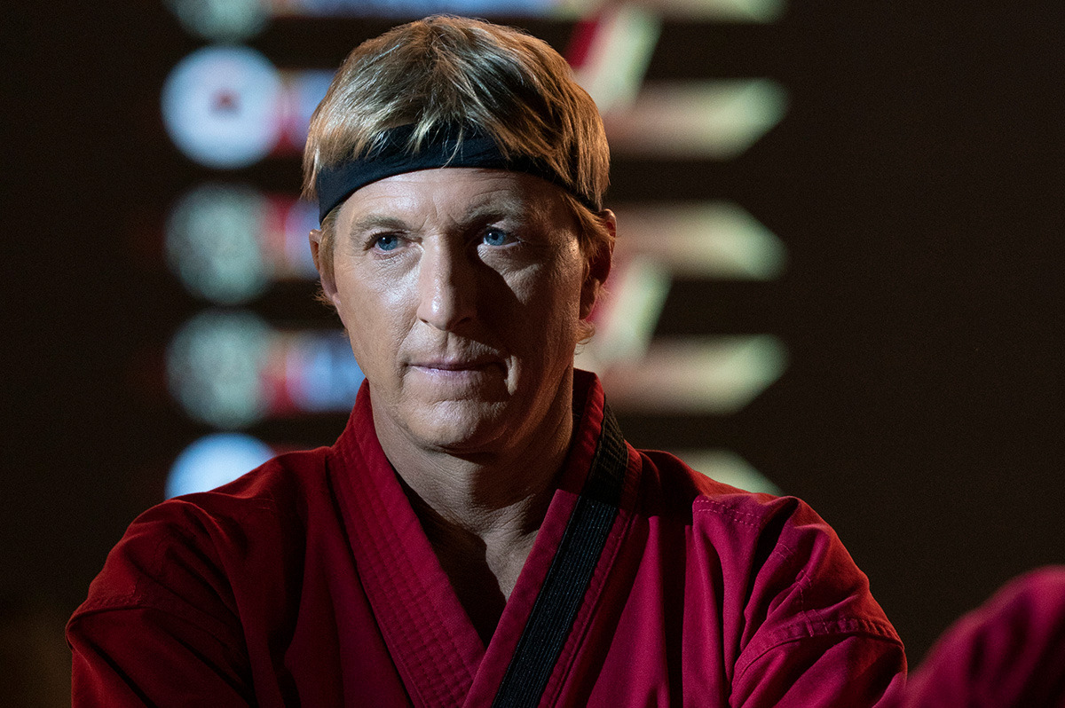  A man with blonde hair wearing a red karate Gi.