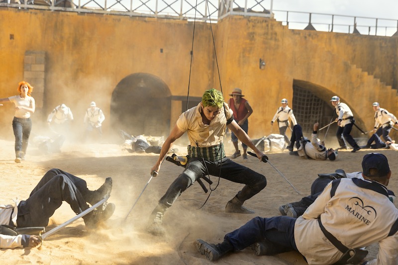 Emily Rudd as Nami, Mackenyu as Roronoa Zoro, and Iñaki Godoy as Monkey D. Luffy filming a stunt scene on set of Season 1 of 'One Piece.'