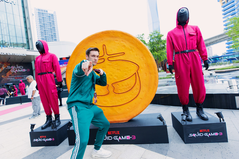 A fan poses in front of a dalgona at a 'Squid Game' Season 3 event in Kuala Lumpur, Malaysia.