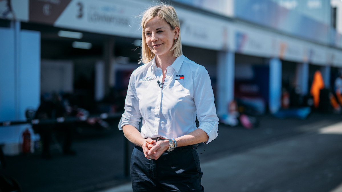 Susie Wolff walks across the paddock.